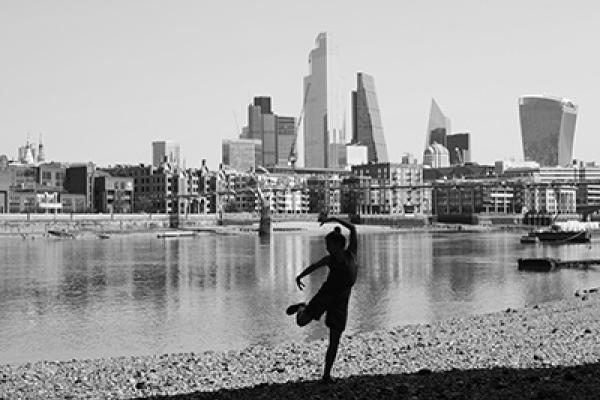 Suzannah Hall dancing by the Thames with London skyline as background