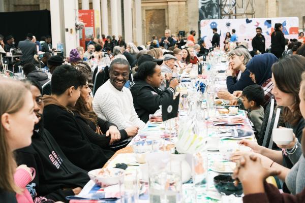 Smiling guests sitting at a large banqueting table
